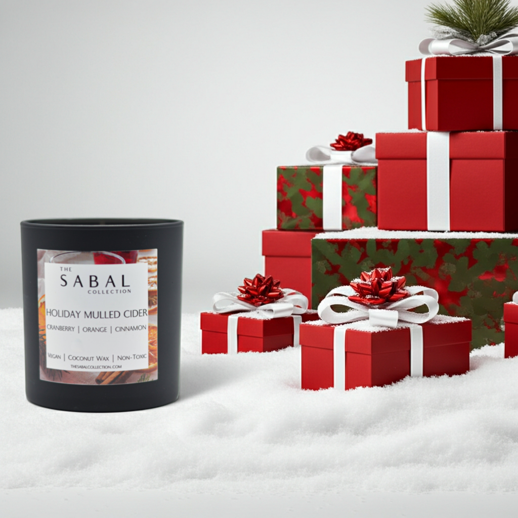 Sabal Holiday Mulled Cider candle with Christmas presents on a snowy background